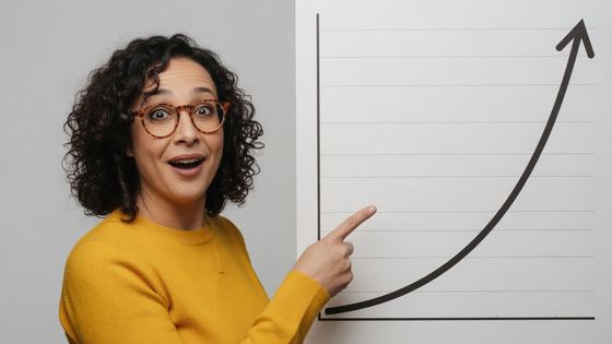 Creator points at a printed chart curving sharply upward with genuine surprise
